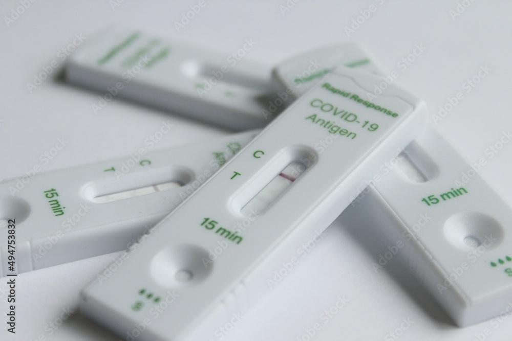 Positive and negative Covid19 coronavirus rapid response antigen tests in white plastic boxes
