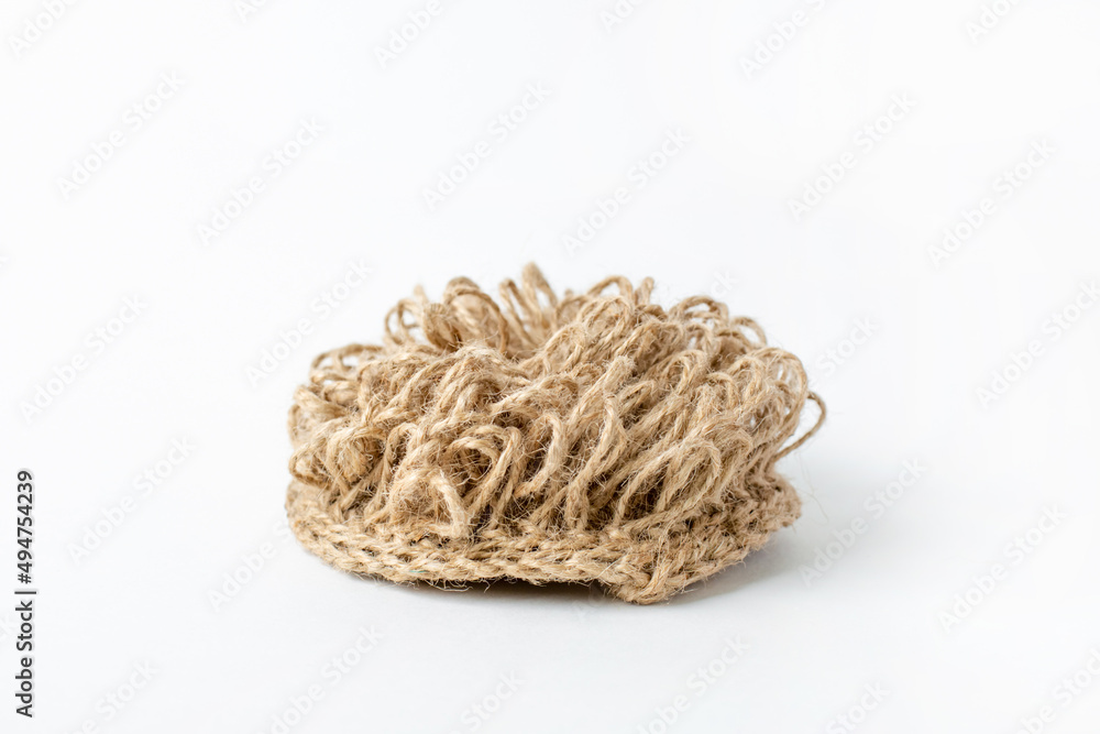 Natural washcloth made of craft thread for washing dishes. The concept of waste-free production , zero waste on white background isolated Natural washcloth made of craft thread for washing dishes. The concept of waste-free production , zero waste on white background isolated