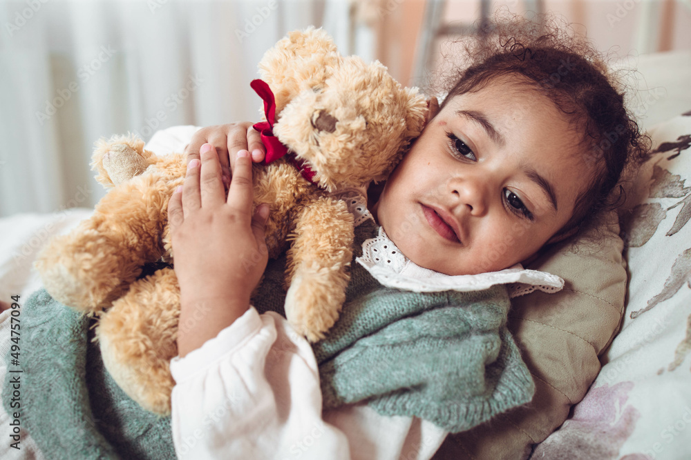 Adorable multiethnic little girl hugging her bear Adorable multiethnic little girl hugging her bear