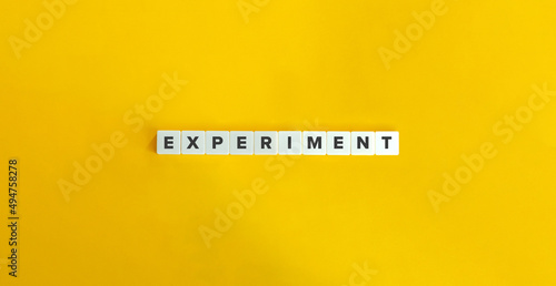 Experiment Word on Letter Tiles on Yellow Background. Minimal Aesthetics.