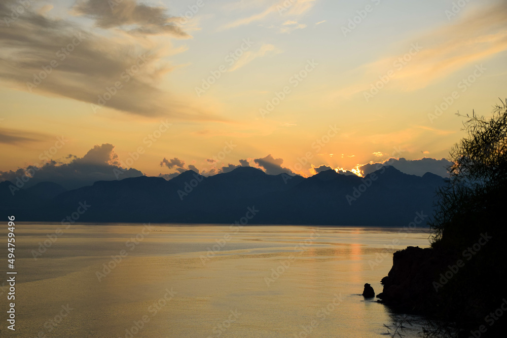 Stunning sunset over the sea with mountains in Antalya, Turkey