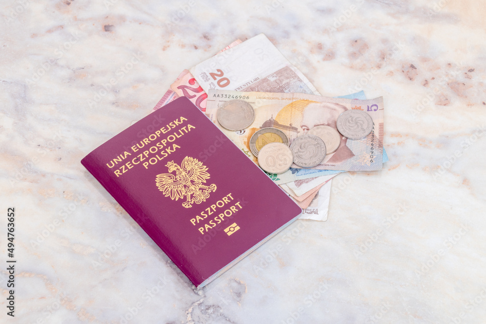 Ureope Union and Polish biometric passport (Unia Europejska Rzeczpospolita Polska) with Georgian lari (GEL) banknotes and coins on table. Ureope Union and Polish biometric passport (Unia Europejska Rzeczpospolita Polska) with Georgian lari (GEL) banknotes and coins on table.