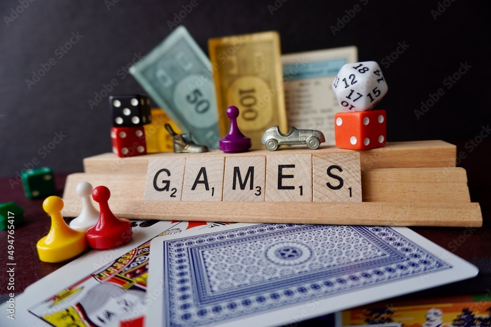 GAME pieces from Monopoly, Scrabble, Clue, playing cards, and dice