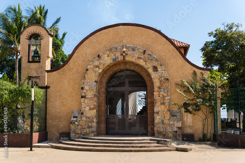 Chapel of Santa Cruz in Huatulco, Oaxaca, Mexico. Famous for wood cross relic. A bearded man brought log to beach. Worshiped after it resisted attack from pirates Francis Drake and Thomas Cavendish. photo