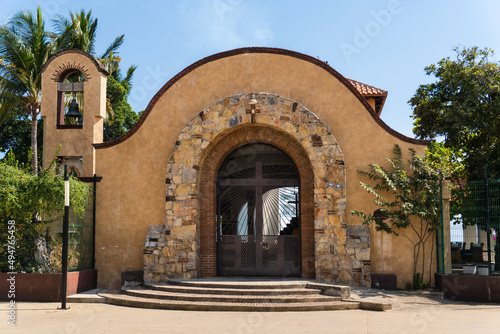 Chapel of Santa Cruz in Huatulco, Oaxaca, Mexico. Famous for wood cross relic. A bearded man brought log to beach. Worshiped after it resisted attack from pirates Francis Drake and Thomas Cavendish.