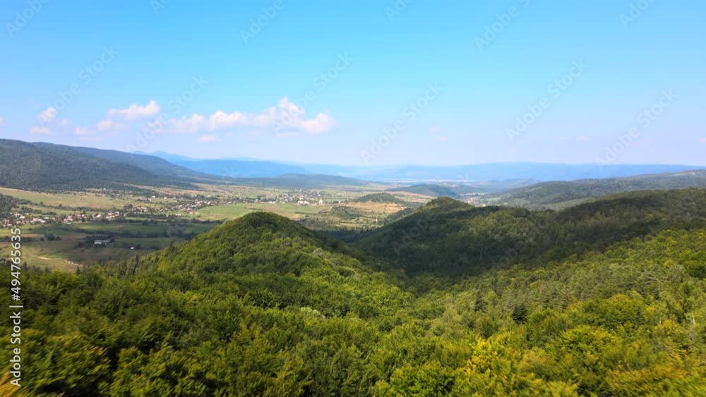 Aerial view of mountain hills covered with dense green lush woods on bright summer day Aerial view of mountain hills covered with dense green lush woods on bright summer day