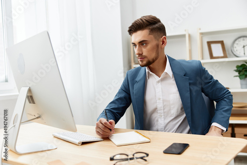 handsome businessman computer desktop work self-confidence paper folder isolated background © SHOTPRIME STUDIO