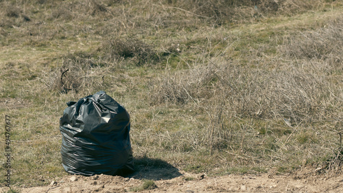 Plastic garbage bag in the field