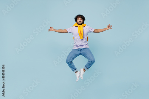 Full size young bearded Indian man 20s years old wears white t-shirt hold spreading hands in yoga om aum gesture relax try to calm down isolated on plain pastel light blue background studio portrait. © ViDi Studio