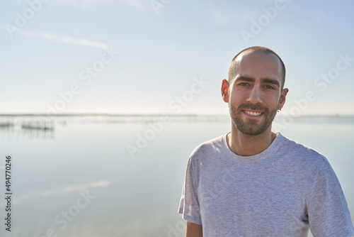 Young male smiling by the beach