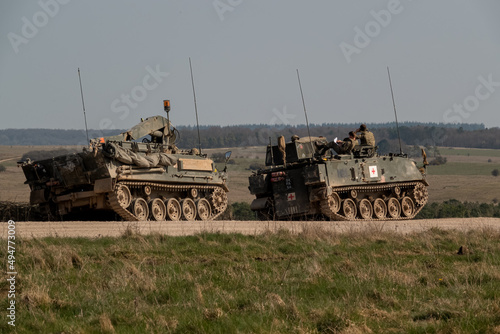 FV434 British Army (REME) Bulldog Armoured Repair Vehicle with 3-ton crane with an FV432 Bulldog Ambulance armoured personnel carrier on a military exercise photo