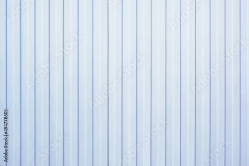 White and blue corrugated metal fence.