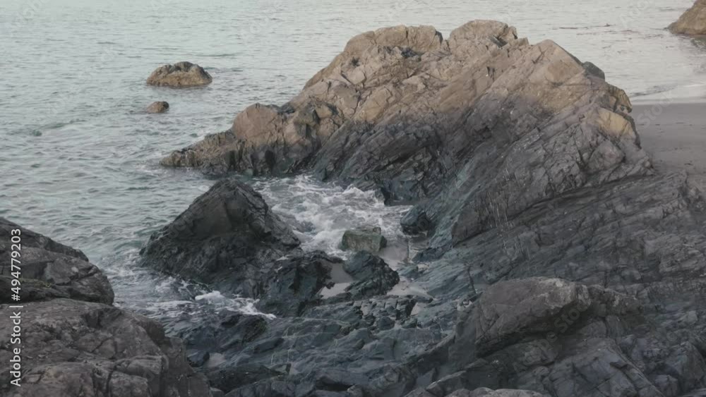 Large waves crashing into a rocky cliff face in washington Large waves crashing into a rocky cliff face in washington