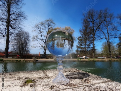 Cesis, May park fountain seen through crystal ball, background blurry  photo