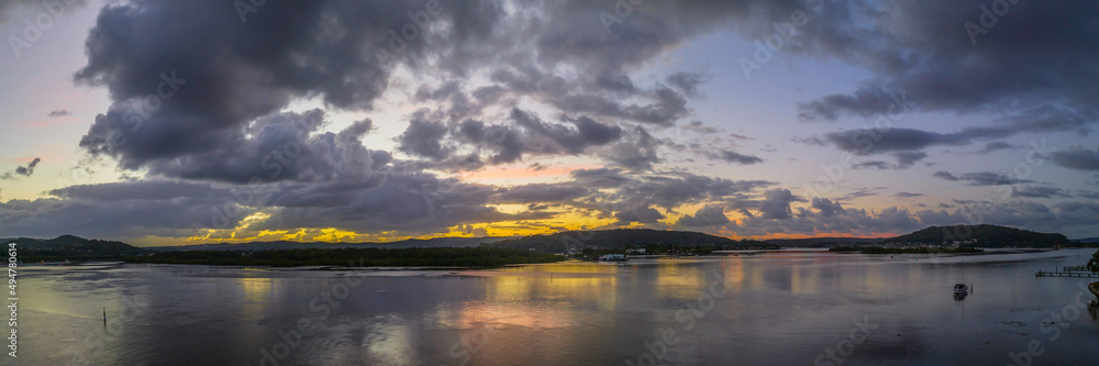 Sunrise and rain clouds panorama waterscape