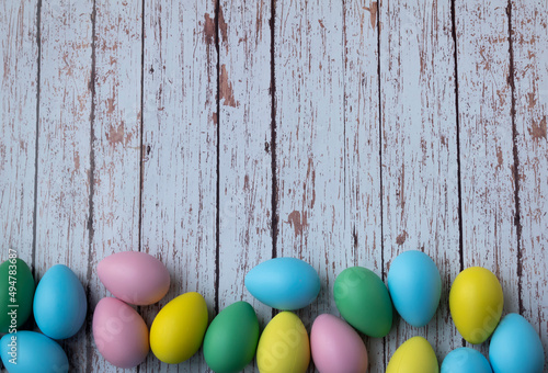Colorful easter eggs on wooden background. Copy space. Horizontal.