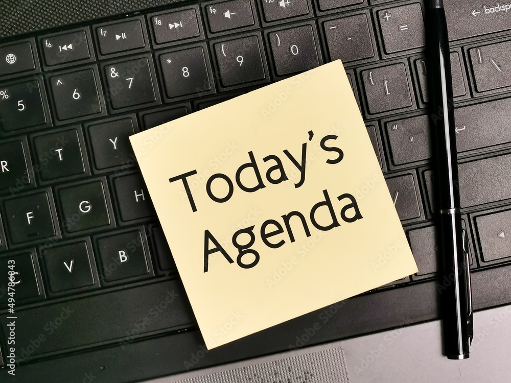 Top view image of sticky note written today's agenda with a pen and keyboard. Top view image of sticky note written today's agenda with a pen and keyboard.