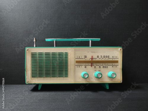old transistor radio on black wallpaper background