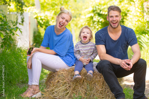 Young family of three having fun together launching. Funny parents playing with son smiling outdoor. Father mother and child playing together. © Volodymyr