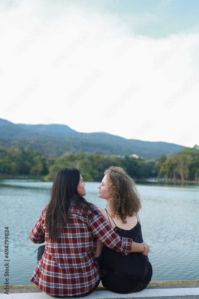 Beautiful women LGBT Lesbian Couple intimate moments. Young couple multiracial female friends. multi-ethnic female couple in love hug each other