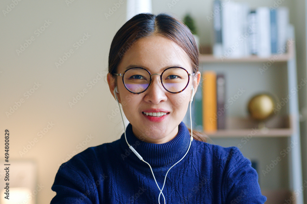 Young Asian woman creator wearing glasses and headphone talking on