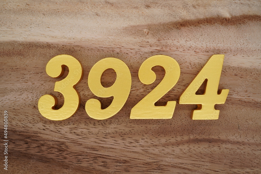Golden Arabic numerals on a real brown and white wooden floor number ...