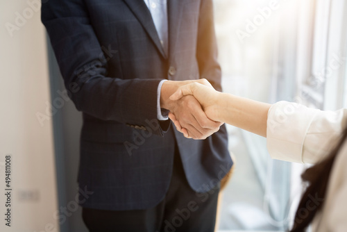 Business asian agreement and successful negotiation concept, businessman in suit shake hand with customer, client after formal communication and contract deal success