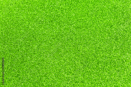 Lime glitter twinkle abstract spring or summer holiday background with sparkles. Modern luxury mock up with sequins. Texture of colored porous rubber with spangles