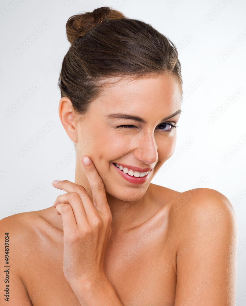 Lets keep my beauty tips between us okay. Studio portrait of a beautiful young woman giving you a wink. Lets keep my beauty tips between us okay. Studio portrait of a beautiful young woman giving you a wink.