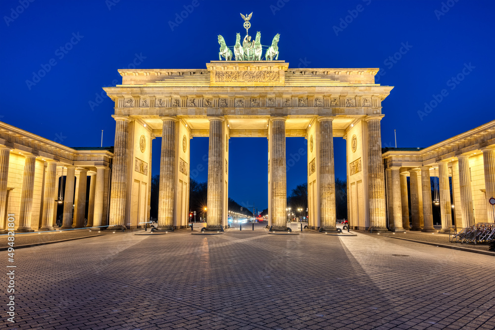 The famous illuminated Brandenburg Gate in Berlin at twilight