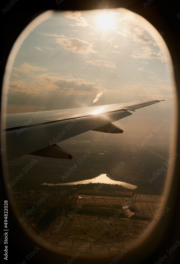 Soaring through the air on silver wings. Shot of the view through an airplane window. Soaring through the air on silver wings. Shot of the view through an airplane window.