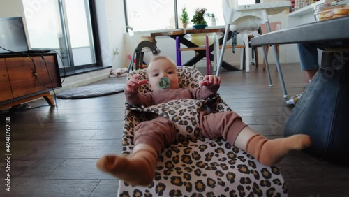 Small baby boy bouncing in his crib at home