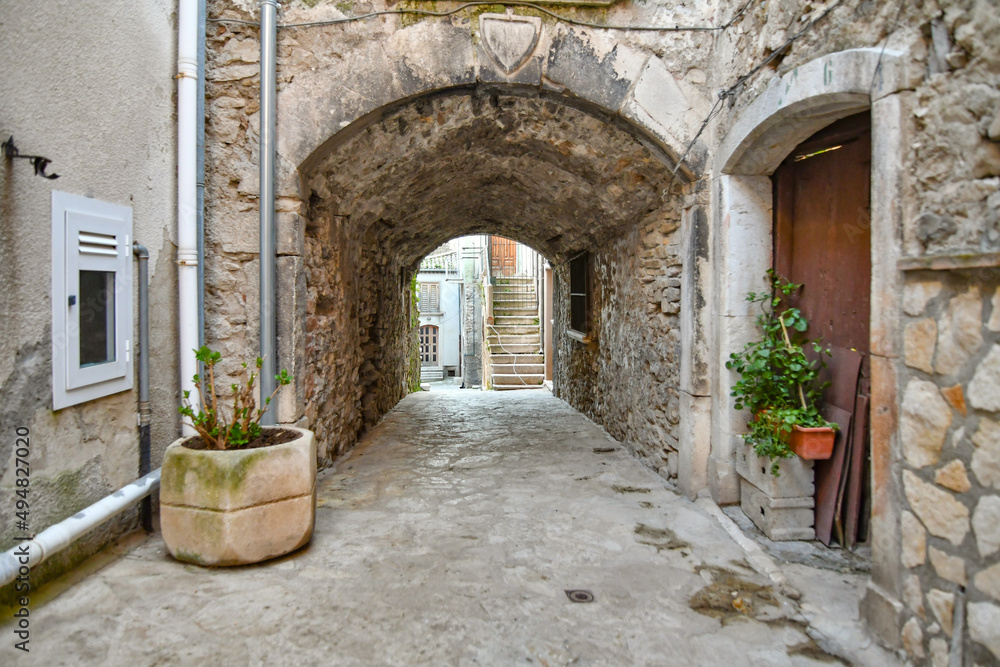 A narrow street among the old stone houses of Taurasi, town in Avellino province, Italy.