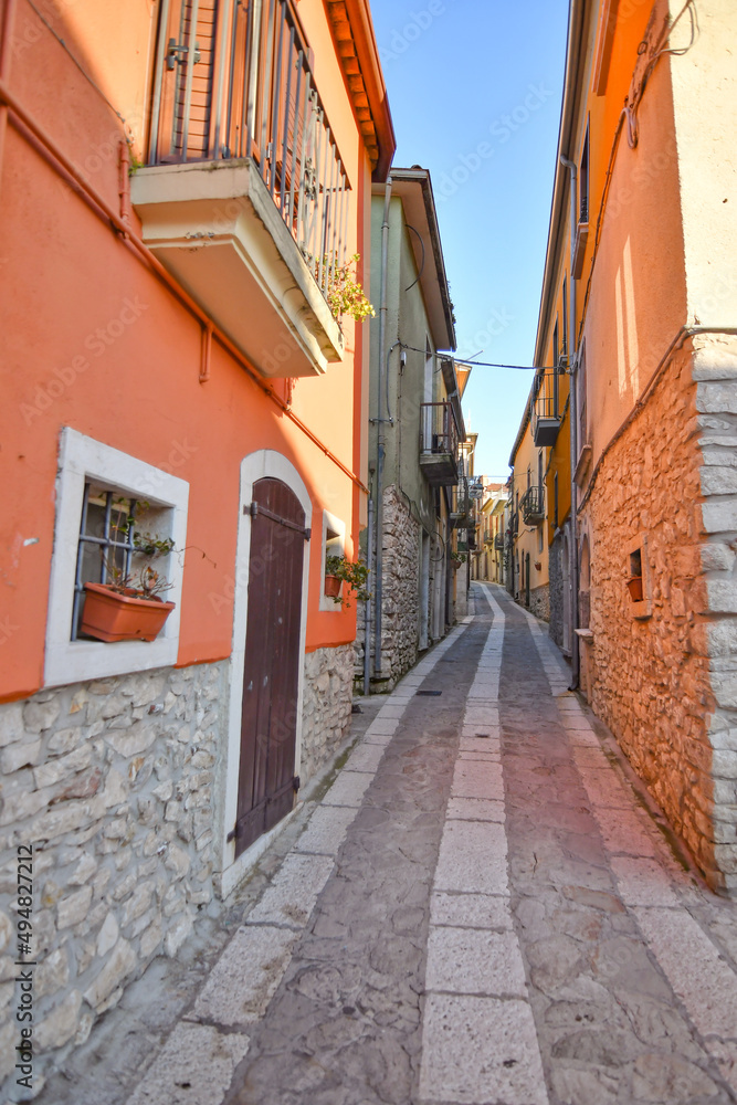 Fototapeta premium A narrow street among the old stone houses of Taurasi, town in Avellino province, Italy.