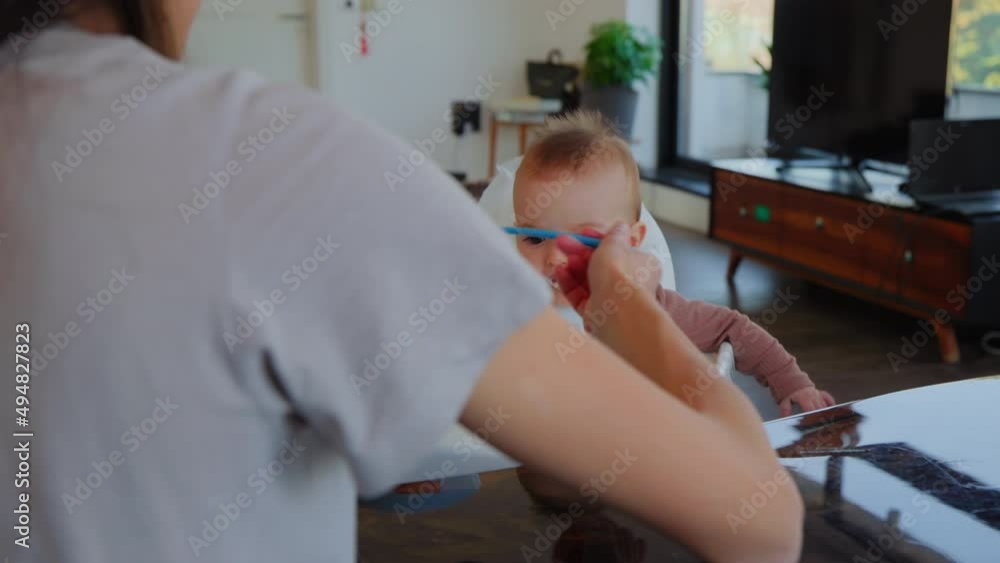 Mom feeds baby in the living room Mom feeds baby in the living room