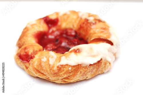 Cherry filled Danish or Danish bread placed on a white background.