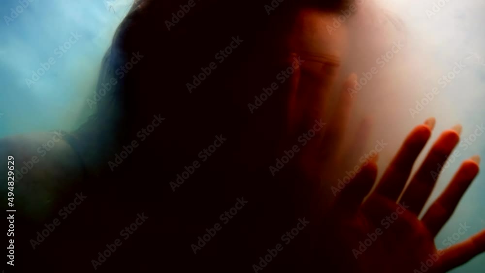 woman is floating underwater and disappearing in clouds of white smoke, abstract fantastic portrait woman is floating underwater and disappearing in clouds of white smoke, abstract fantastic portrait