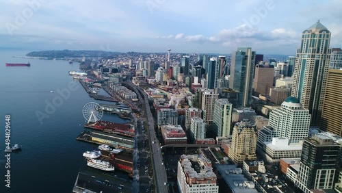 Drone shot of the Seattle waterfront showcasing where the Puget Sound meets the city skyline. photo