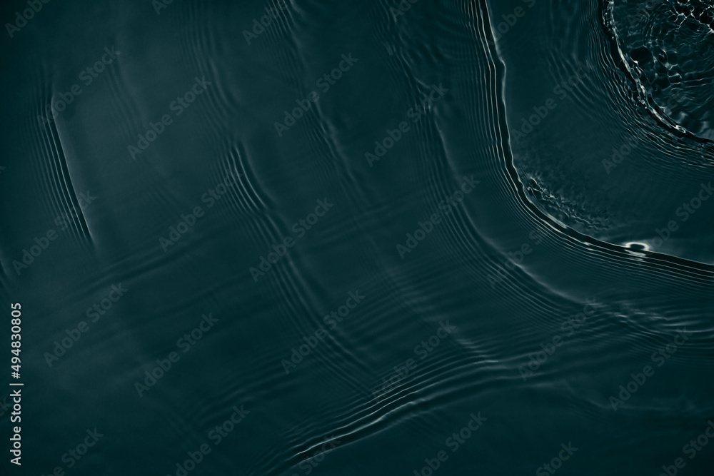 Black transparent clear calm water surface texture with ripples, splashes Abstract nature background. Dark grey water waves in sunlight Copy space Cosmetic moisturizer micellar toner emulsion Black transparent clear calm water surface texture with ripples, splashes Abstract nature background. Dark grey water waves in sunlight Copy space Cosmetic moisturizer micellar toner emulsion