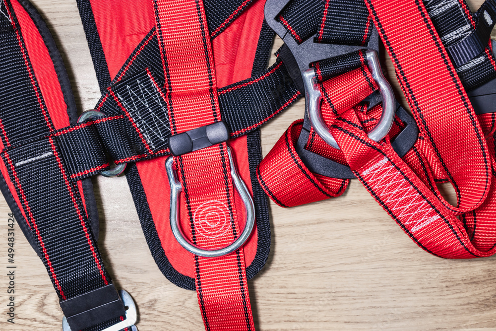 Safety belt for work at height with carabiner. Professional safety equipment for mountaineering