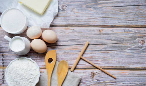 Various cooking ingredients (milk, butter, flour, eggs)