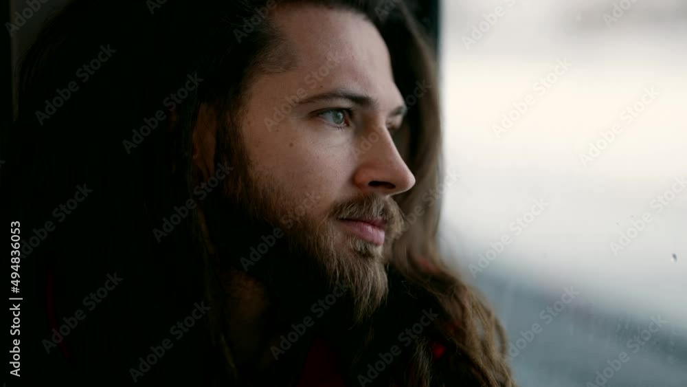 young handsome man in train, looking at window, close up portrait, pensive guy travelling by train young handsome man in train, looking at window, close up portrait, pensive guy travelling by train