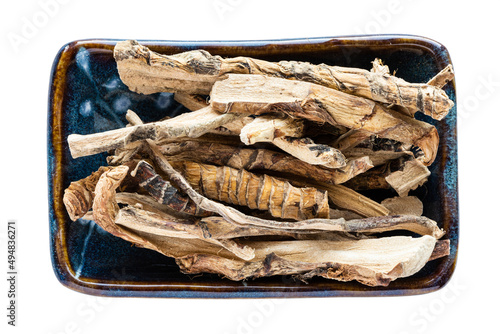 portion of dried Sweet flag (calamus) roots in bowl isolated on white background photo