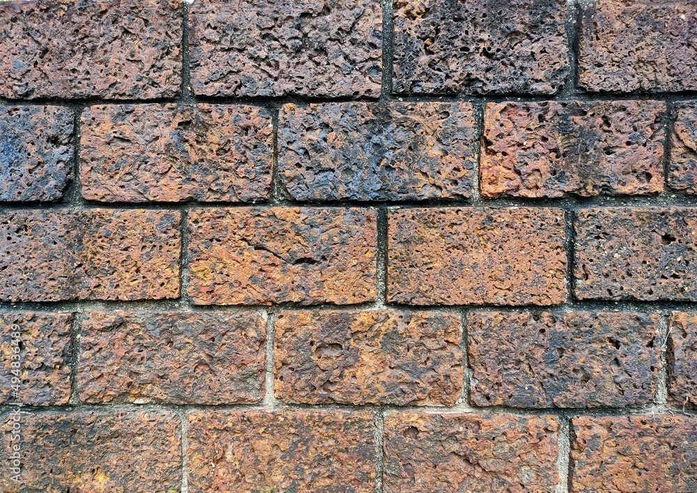 Rustic stone wall of ancient building. brown weathered rock closeup. Rough stone solid wall closeup photo. Stone wall texture. Durable old stone wall pattern. Rustic stone wall of ancient building. brown weathered rock closeup. Rough stone solid wall closeup photo. Stone wall texture. Durable old stone wall pattern.
