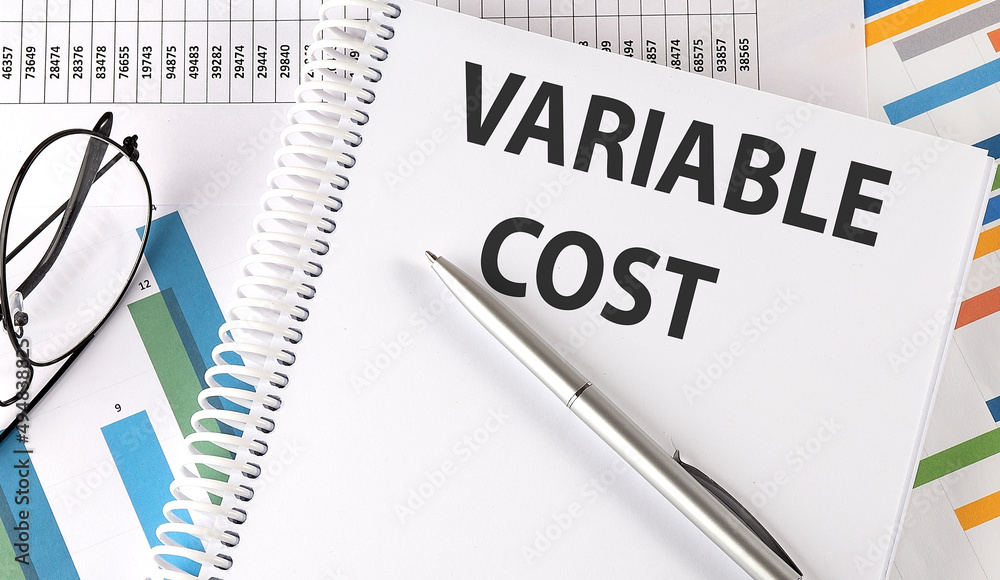 VARIABLE COST , pen and glasses on the chart, business concept VARIABLE COST , pen and glasses on the chart, business concept