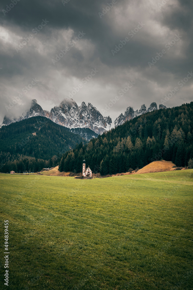 landscape with church and dolomites mountains in italy