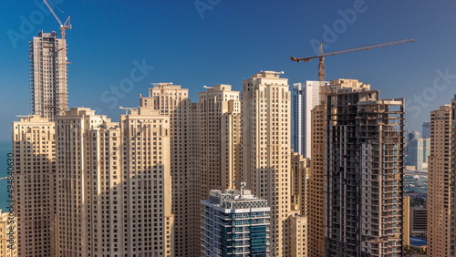 Jumeirah Beach Residence and original architecture yellow towers in Dubai aerial timelapse.