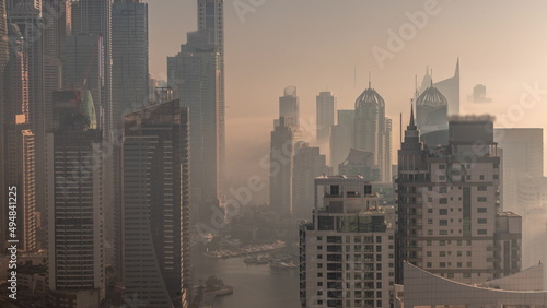 View of various skyscrapers in tallest recidential block in Dubai Marina aerial timelapse