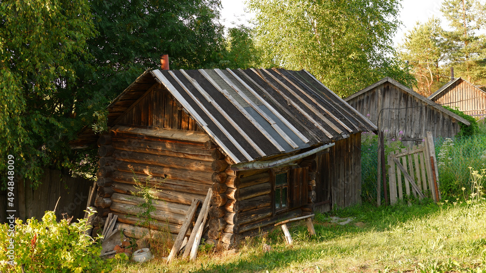 Beautiful rustic summer landscape. Old wooden log houses. Vologda region Beautiful rustic summer landscape. Old wooden log houses. Vologda region