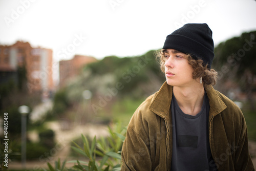 european teenage portrait with wool cap looking sideways with copy space